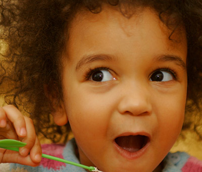 Child with a surprised and excited expression on her face.